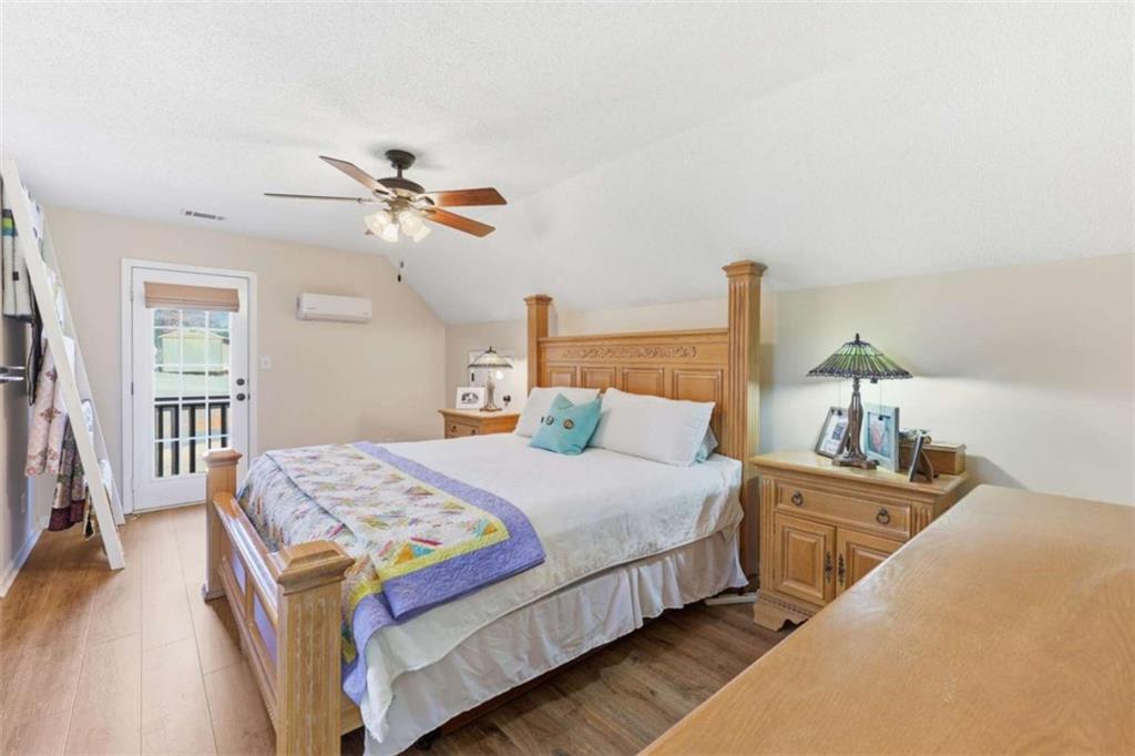 4033 Mt Vernon Road Gainesville, GA 30506 - Photo 24 of 47 a bedroom with bed and a chandelier