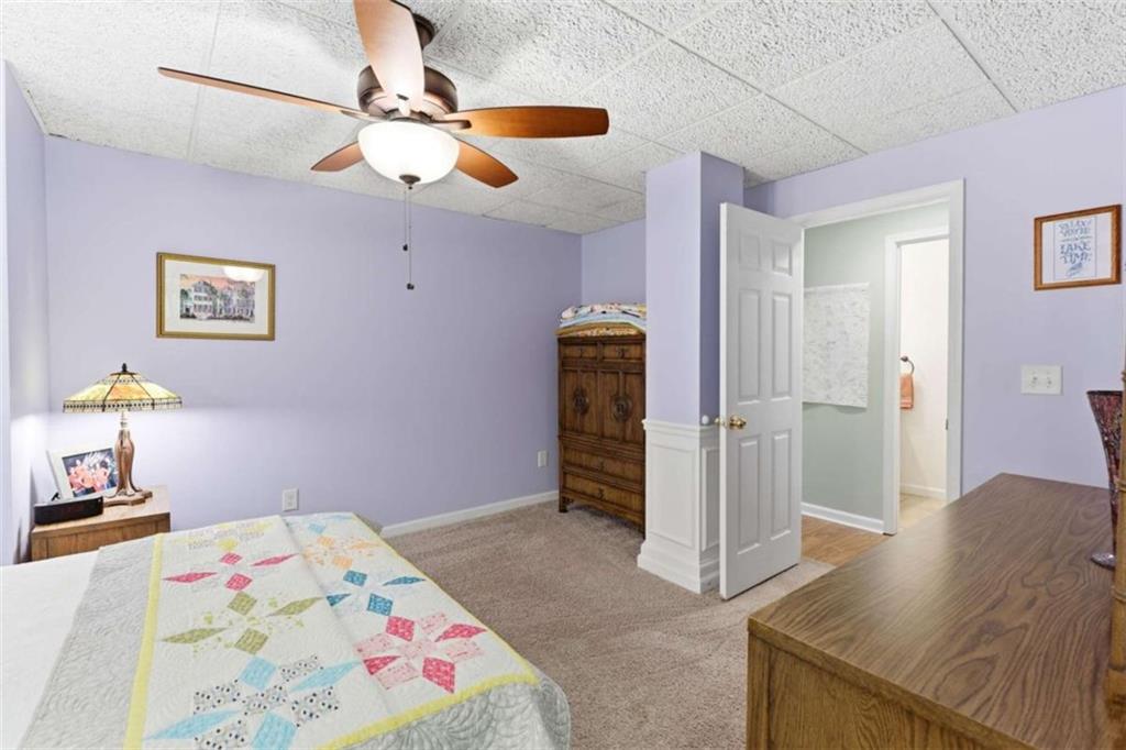 4033 Mt Vernon Road Gainesville, GA 30506 - Photo 34 of 47 a bedroom with a bed and a chandelier