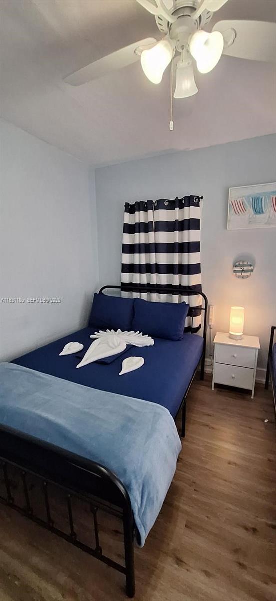 1535 Southwest 2nd Street Miami, FL 33135 - Photo 12 of 38 a bedroom with a bed and a chandelier