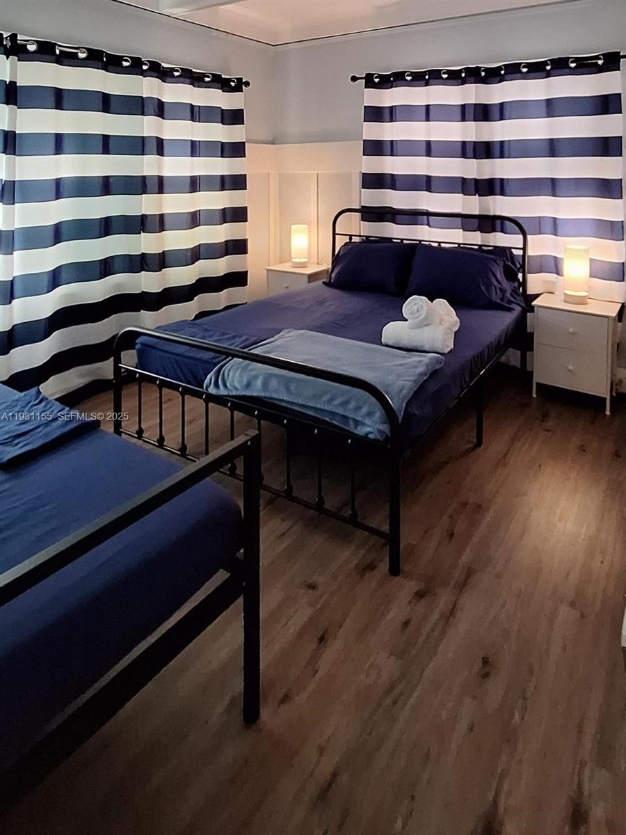 1535 Southwest 2nd Street Miami, FL 33135 - Photo 21 of 38 a bedroom with a bed and a chandelier