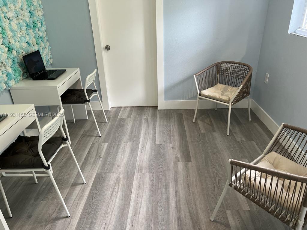 1535 Southwest 2nd Street Miami, FL 33135 - Photo 23 of 38 a view of a workspace with furniture and wooden floor