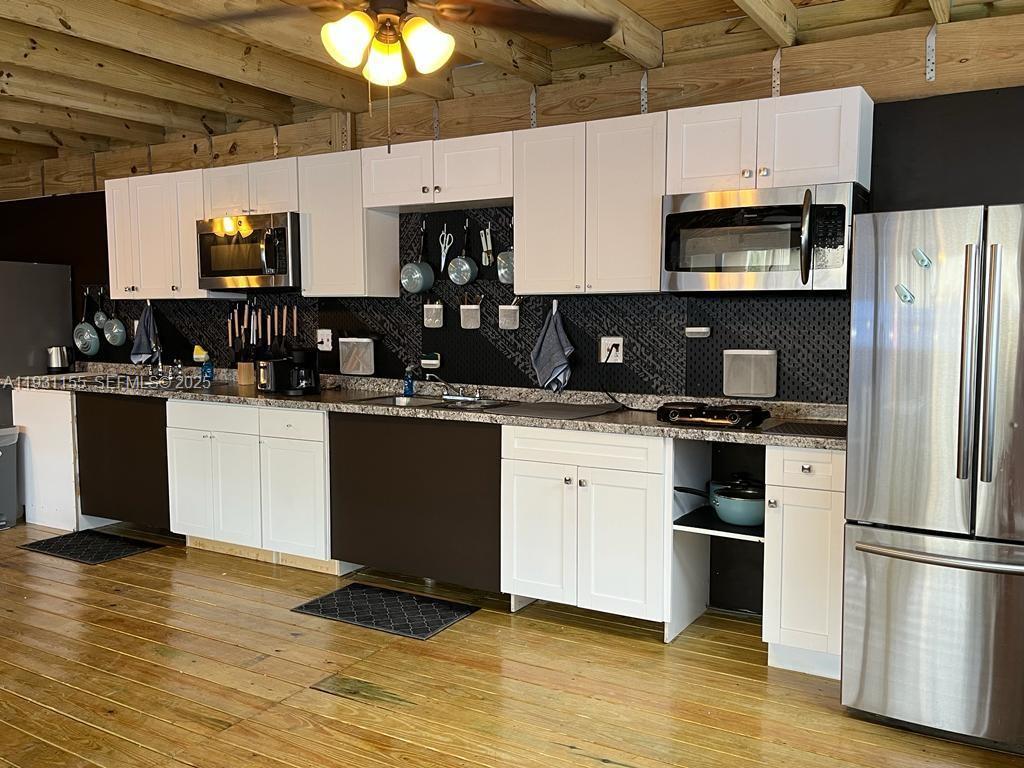 1535 Southwest 2nd Street Miami, FL 33135 - Photo 8 of 38 a kitchen with a sink stainless steel appliances and white cabinets