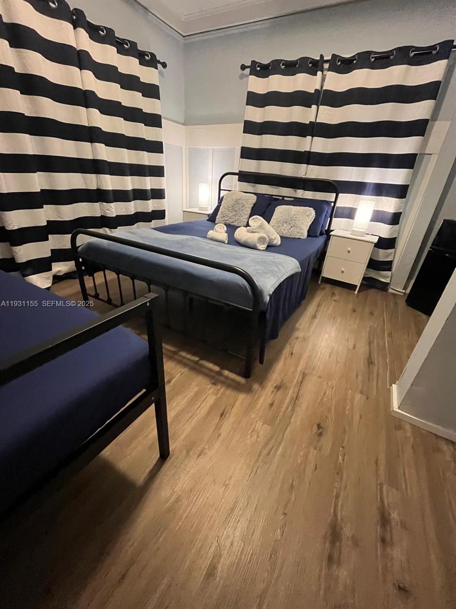 1535 Southwest 2nd Street Miami, FL 33135 - Photo 9 of 38 a bedroom with a bed and wooden floor