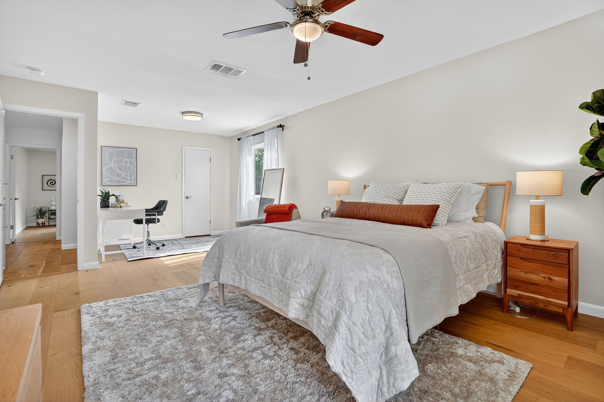 3202 Western Drive Austin, TX 78745 - Photo 15 of 34 a spacious bedroom with a bed a dresser and flowerpot