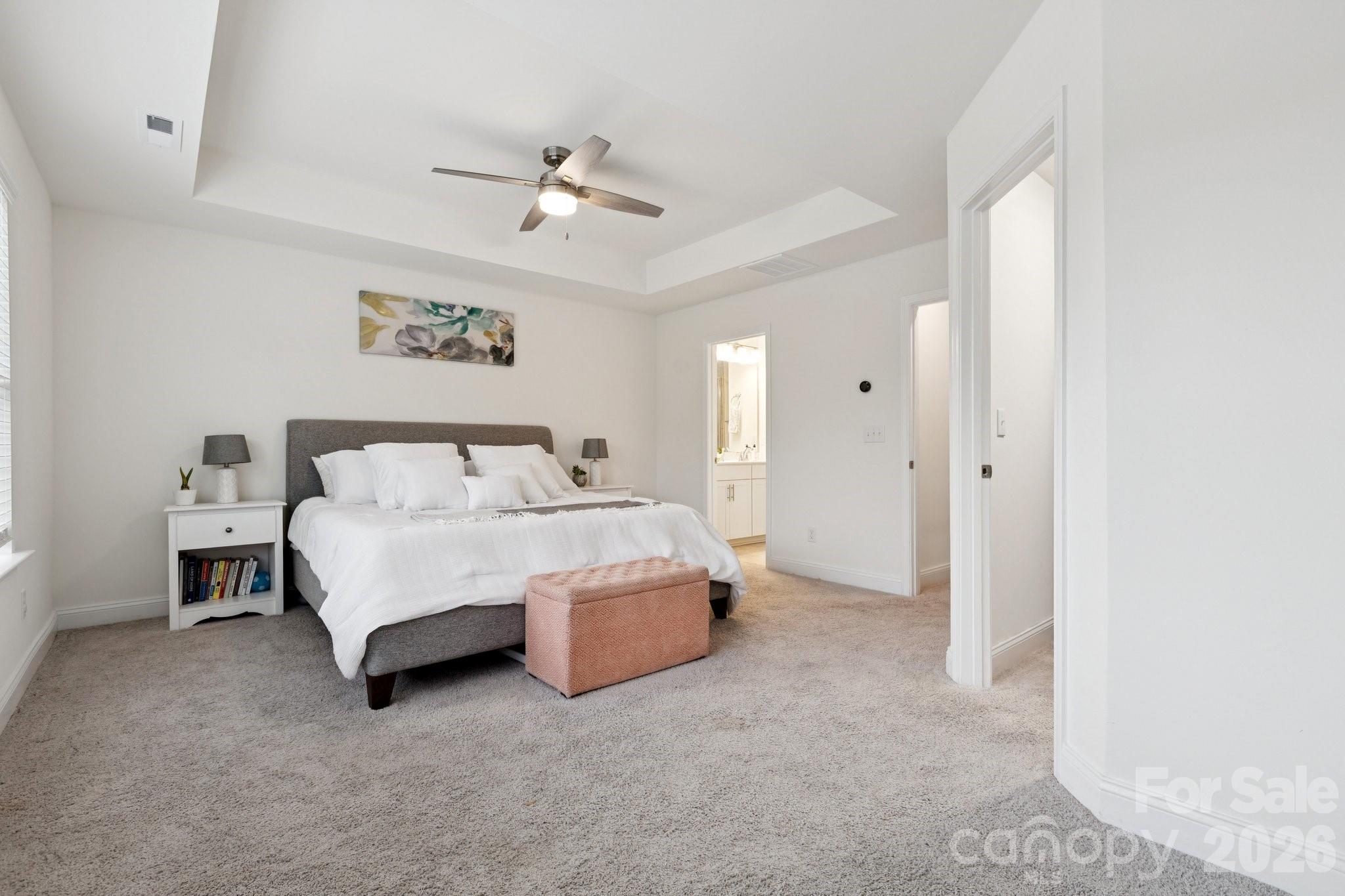 2081 Suttonview Road Fort Mill, SC 29708 - Photo 14 of 33 a spacious bedroom with a bed and a chandelier