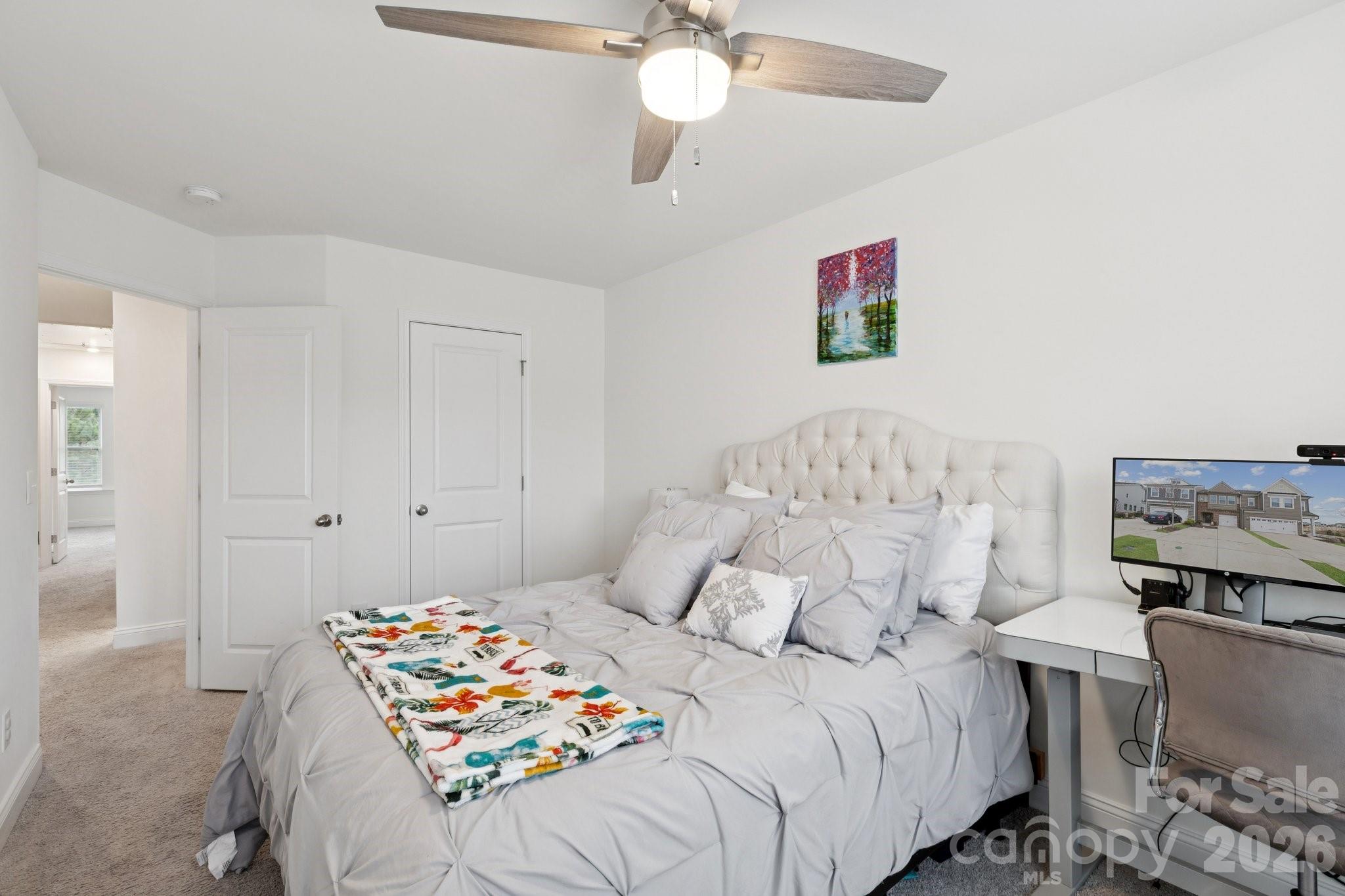2081 Suttonview Road Fort Mill, SC 29708 - Photo 23 of 33 a bedroom with a bed and a chandelier