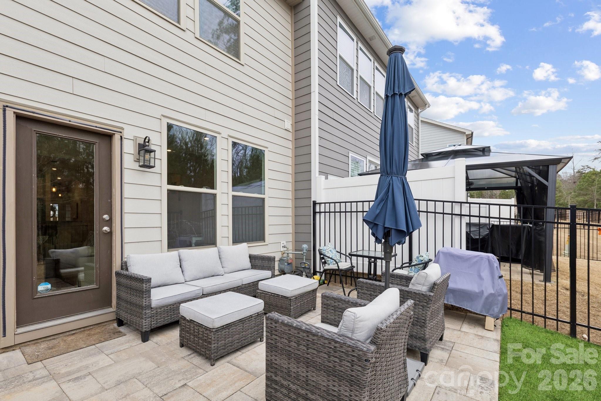 2081 Suttonview Road Fort Mill, SC 29708 - Photo 26 of 33 a view of a patio with couches table and chairs and potted plants