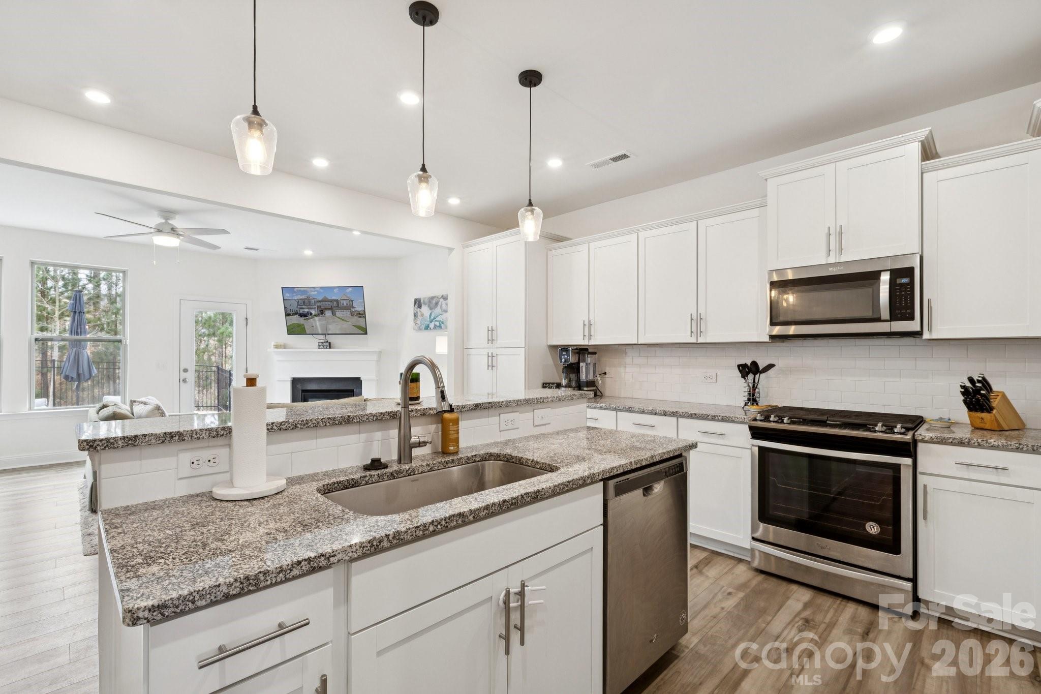 2081 Suttonview Road Fort Mill, SC 29708 - Photo 7 of 33 a kitchen with granite countertop a sink a stove and cabinets