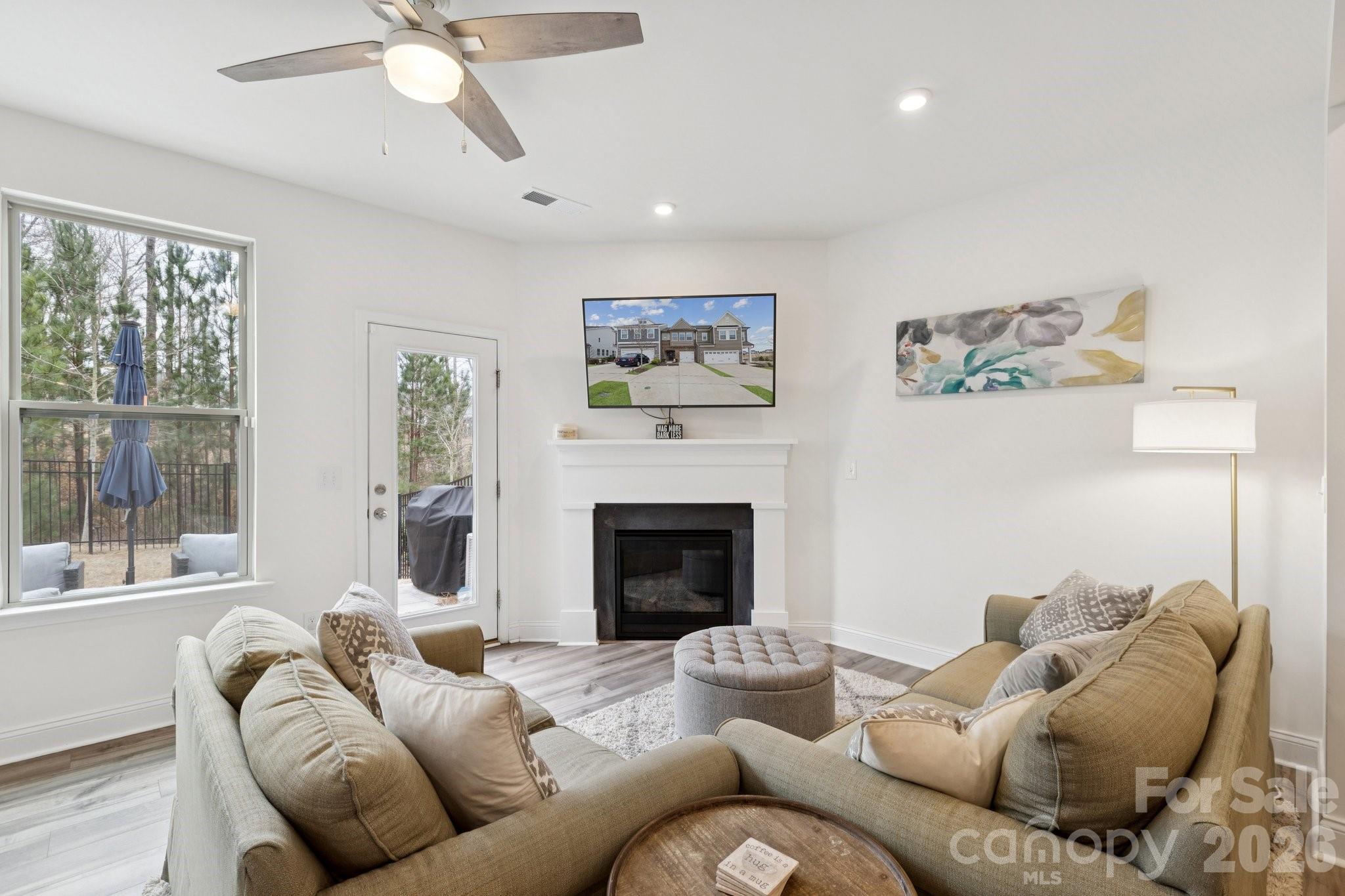 2081 Suttonview Road Fort Mill, SC 29708 - Photo 8 of 33 a living room with furniture and a fireplace