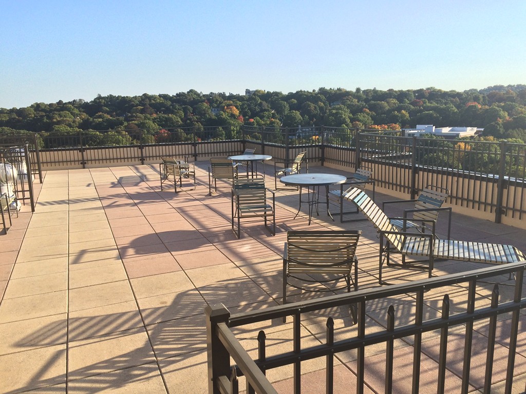 1731 Beacon Street, Unit 1110 Brookline, MA 02445 - Photo 22 of 24 a view of a chairs and table on the terrace