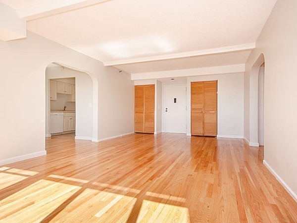 1731 Beacon Street, Unit 1110 Brookline, MA 02445 - Photo 6 of 24 a view of empty room with wooden floor and entryway
