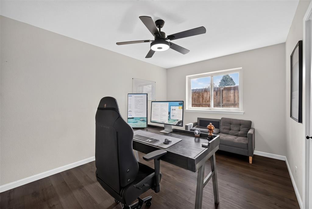 3919 Ridgeoak Way Farmers Branch, TX 75244 - Photo 17 of 28 Room featuring dark wood-finish flooring, light neutral-toned walls, and a white window frame with a multi-pane window