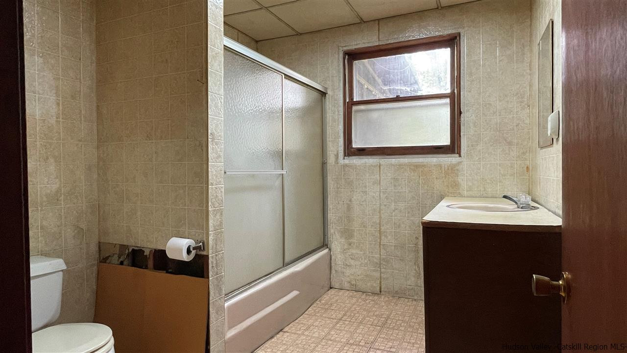 53 Coxing Road Cottekill, NY 12419 - Photo 6 of 13 a bathroom with a sink mirror vanity and toilet