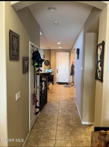 a view of a hallway with furniture