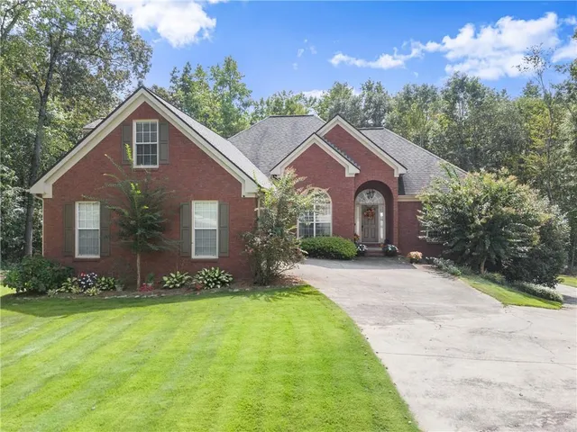 a front view of a house with a yard