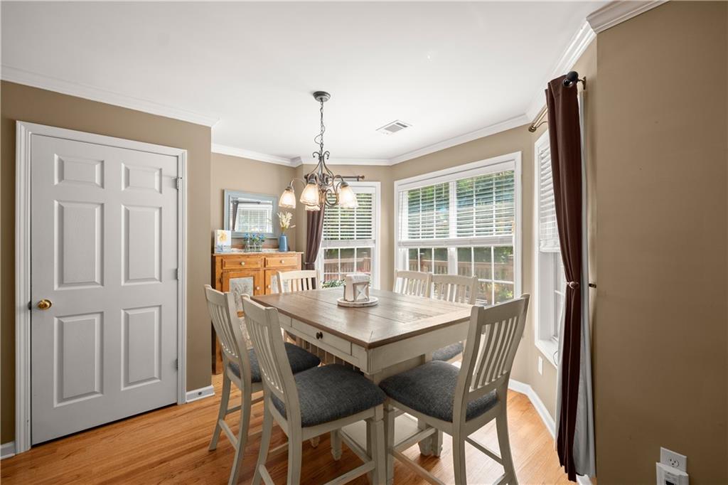 745 Roland Manor Drive Dacula, GA 30019 - Photo 12 of 63 a view of a dining room with furniture wooden floor and chandelier