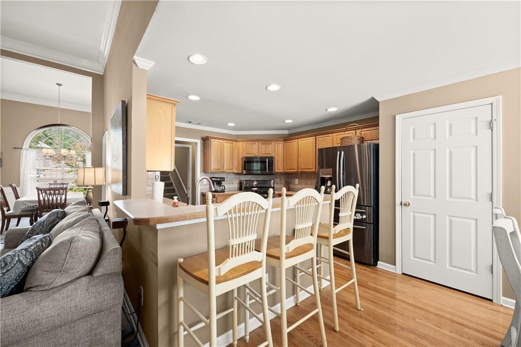 745 Roland Manor Drive Dacula, GA 30019 - Photo 14 of 63 a view of a dining room with furniture window and wooden floor