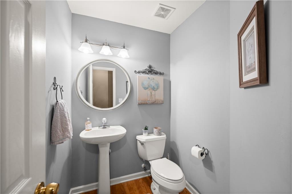 745 Roland Manor Drive Dacula, GA 30019 - Photo 18 of 63 a bathroom with a toilet sink and mirror