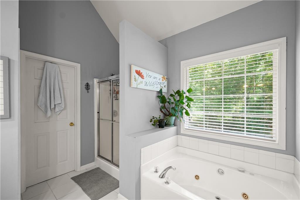 745 Roland Manor Drive Dacula, GA 30019 - Photo 25 of 63 a bathroom with a bathtub and shower