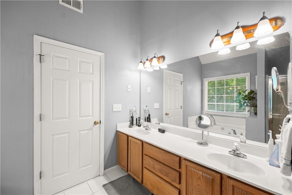745 Roland Manor Drive Dacula, GA 30019 - Photo 26 of 63 a bathroom with a sink double vanity and a mirror