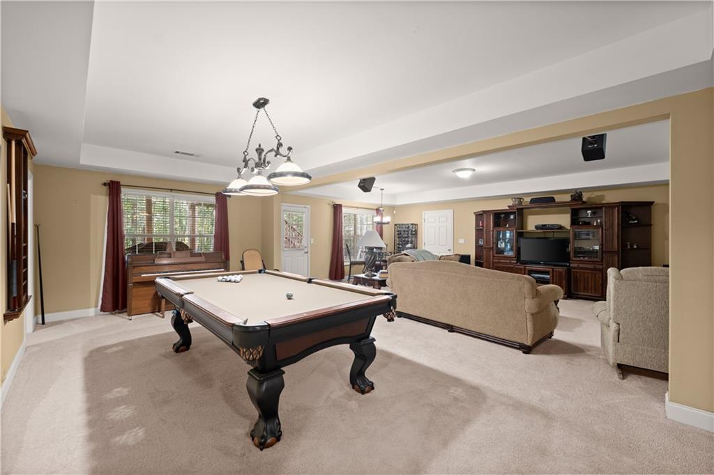 745 Roland Manor Drive Dacula, GA 30019 - Photo 36 of 63 a living room with furniture a chandelier and pool table