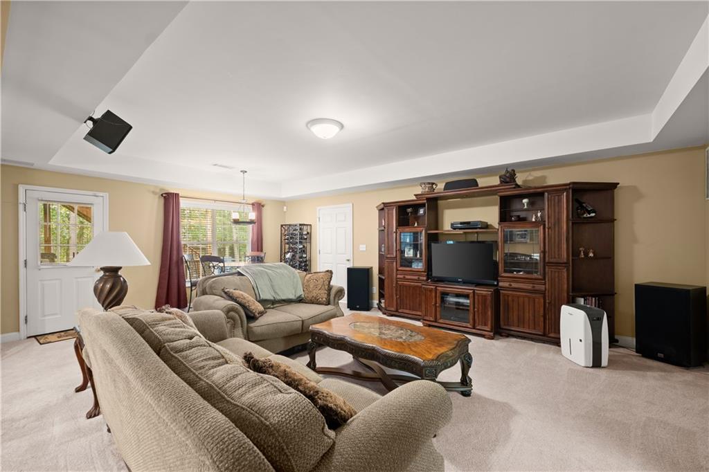 745 Roland Manor Drive Dacula, GA 30019 - Photo 38 of 63 a living room with furniture and a flat screen tv