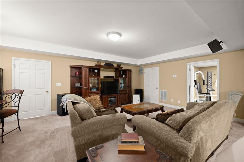 745 Roland Manor Drive Dacula, GA 30019 - Photo 39 of 63 a living room with furniture and a ceiling fan