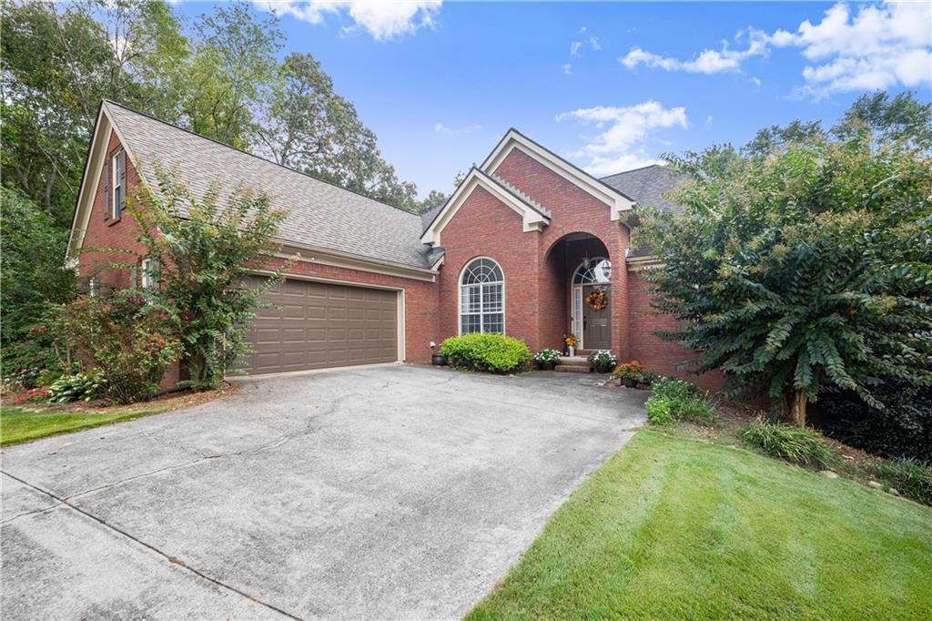 745 Roland Manor Drive Dacula, GA 30019 - Photo 4 of 63 a front view of a house with a yard and garage