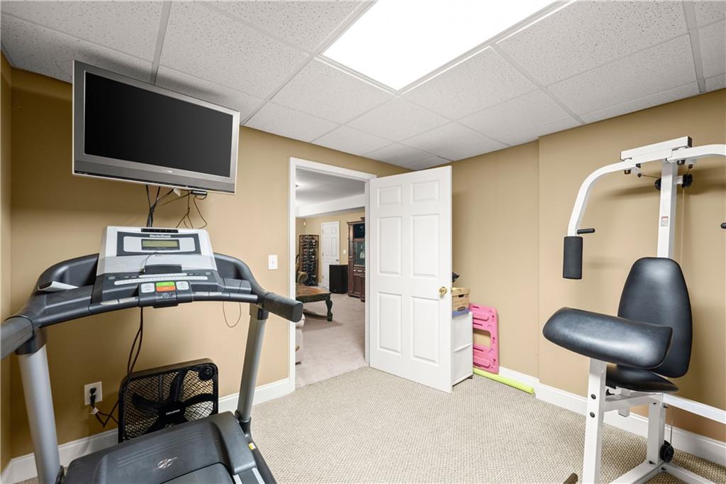 745 Roland Manor Drive Dacula, GA 30019 - Photo 43 of 63 a view of a workspace with furniture and a flat screen tv