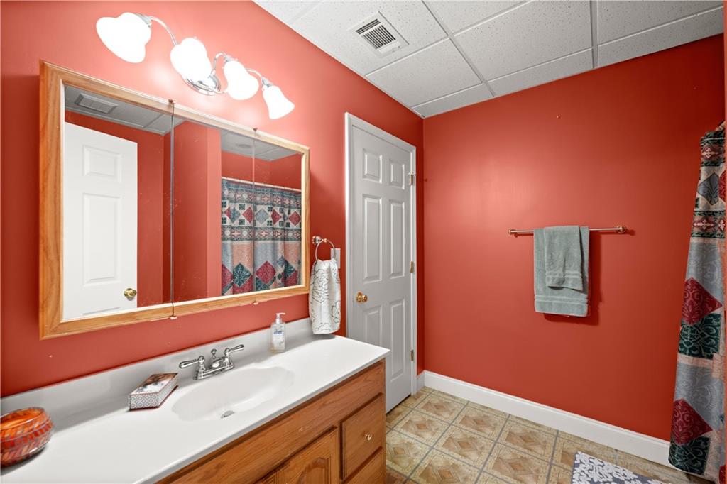 745 Roland Manor Drive Dacula, GA 30019 - Photo 46 of 63 a bathroom with a sink mirror and a shower