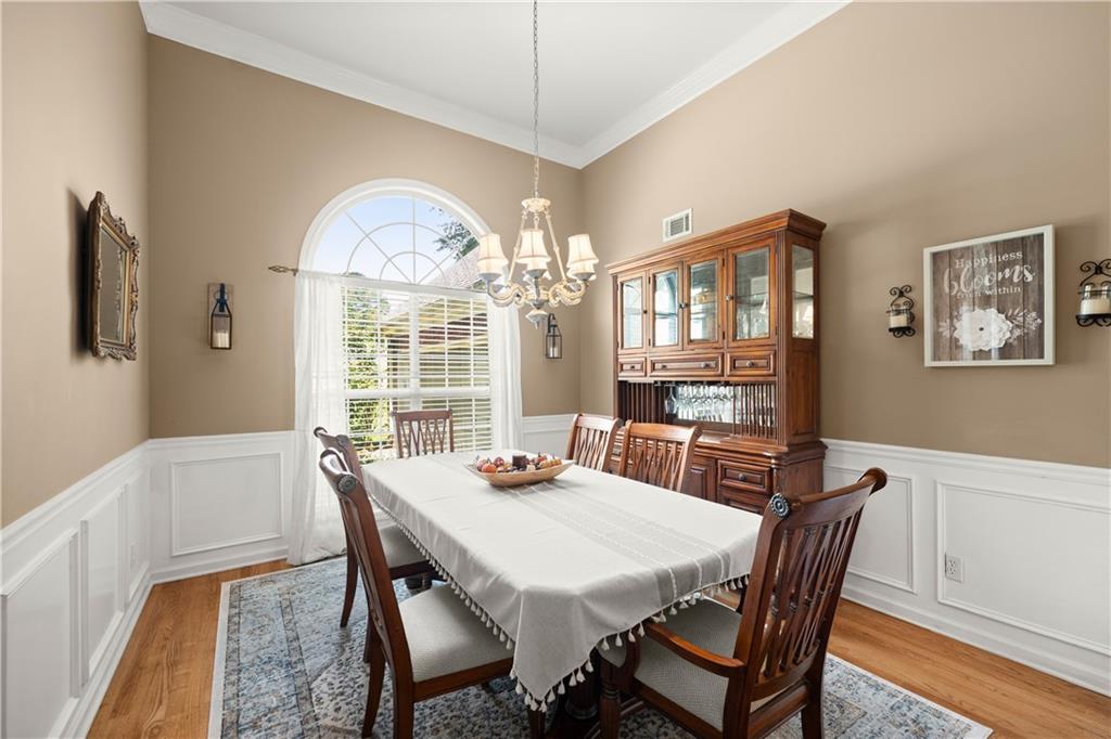 745 Roland Manor Drive Dacula, GA 30019 - Photo 9 of 63 a view of a dining room with furniture window and wooden floor