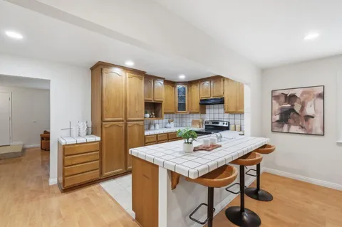 a view of kitchen with cabinets and wooden floor