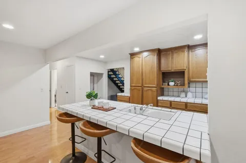 a kitchen with stainless steel appliances kitchen island granite countertop a sink and cabinets