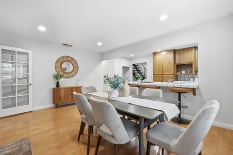 a view of a dining room with furniture and wooden floor