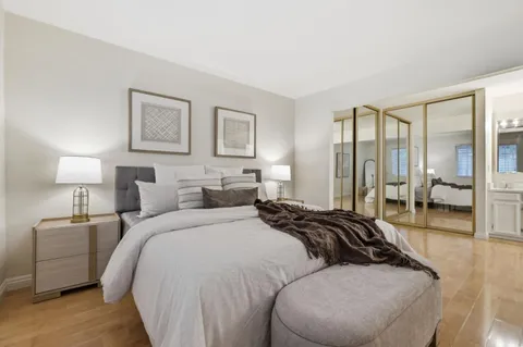 a bedroom with a bed and a night stand