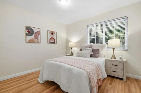 a bedroom with a bed and wooden floor