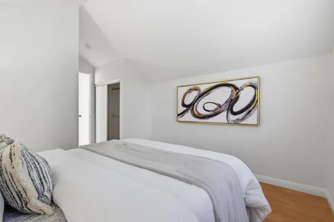 a bedroom with a bed and a wall painting