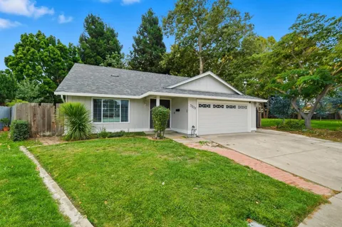 a front view of a house with a garden