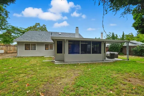 a view of a house with a yard and sitting area