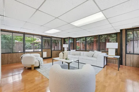 a living room with furniture and large windows