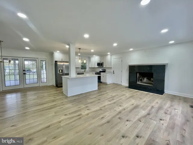a view of kitchen with a sink and a refrigerator