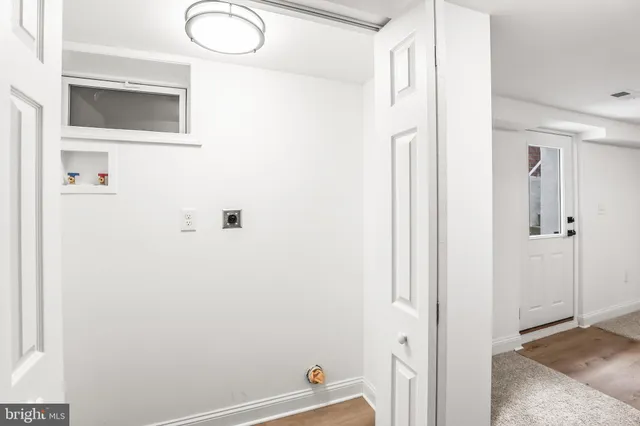a kitchen with a sink cabinets appliances and a window
