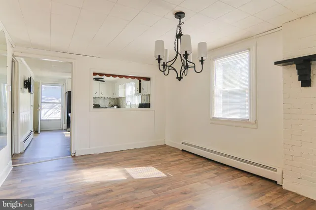 a view of a room with wooden floor windows and staircase
