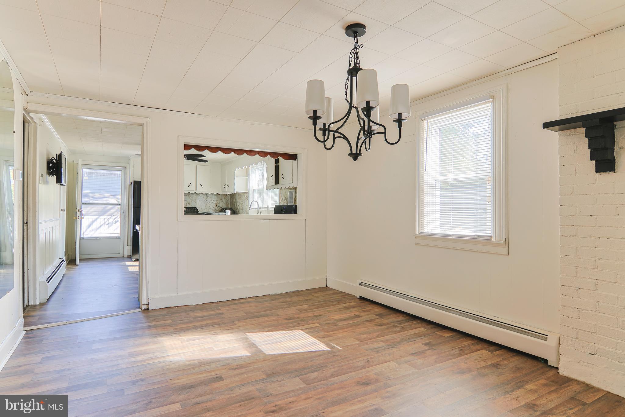 809 Truman Street Cambridge, MD 21613 - Photo 12 of 25 a view of a room with wooden floor windows and staircase