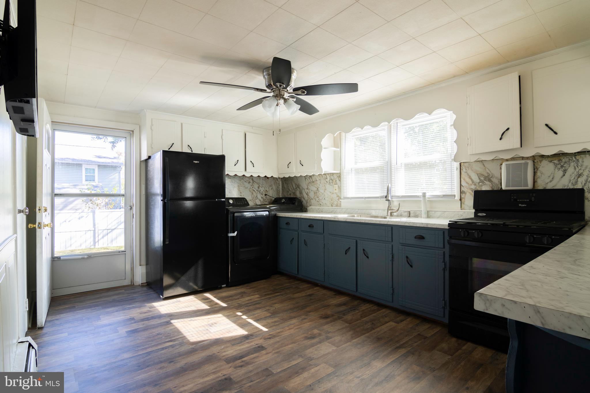 809 Truman Street Cambridge, MD 21613 - Photo 14 of 25 a kitchen with a refrigerator a sink stainless steel appliances and cabinets