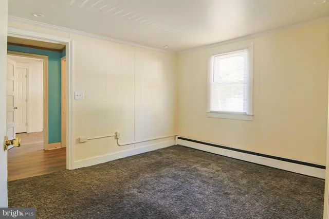 an empty room with a empty space and windows