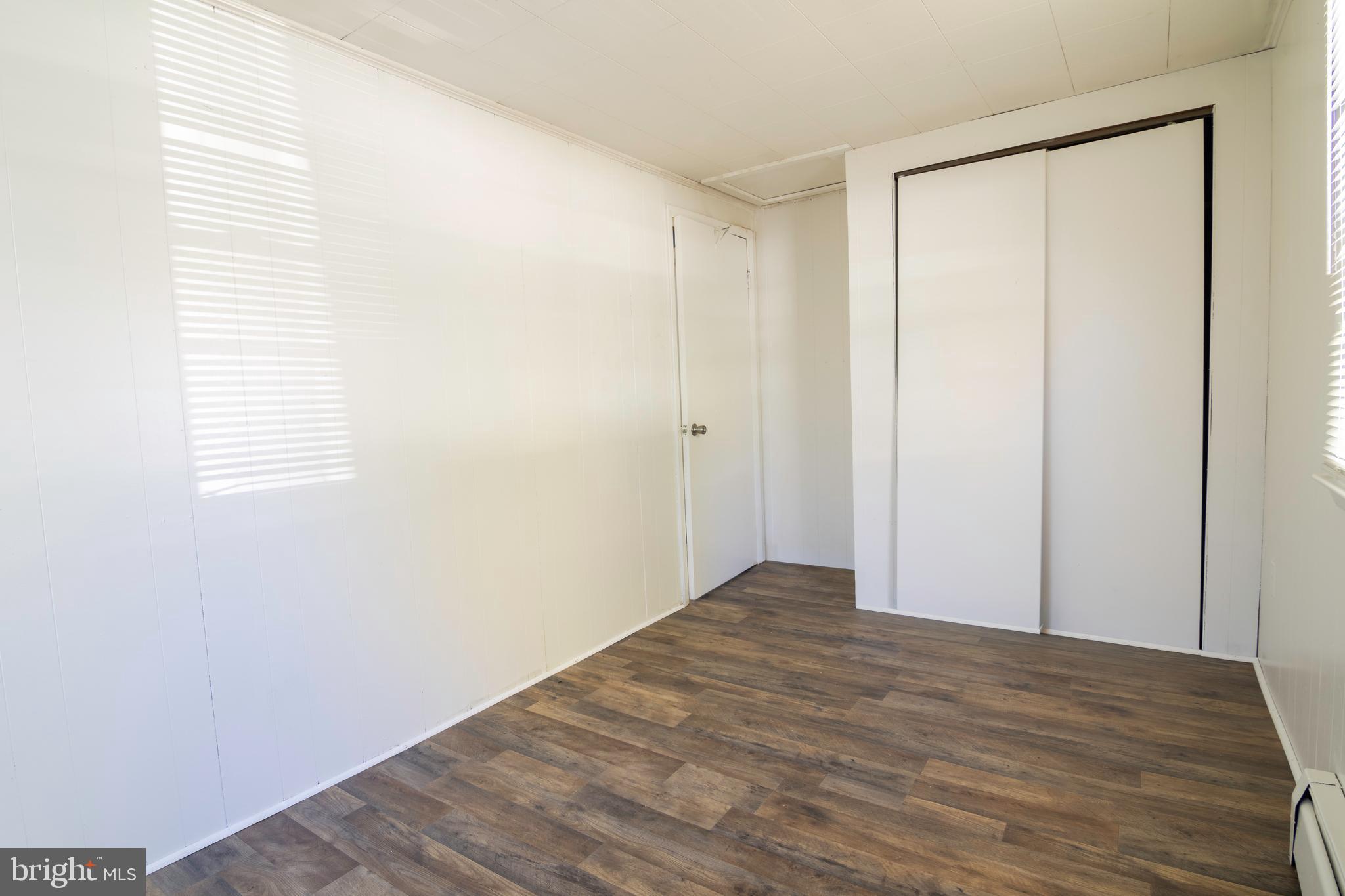 809 Truman Street Cambridge, MD 21613 - Photo 20 of 25 a view of an empty room with wooden floor and a window