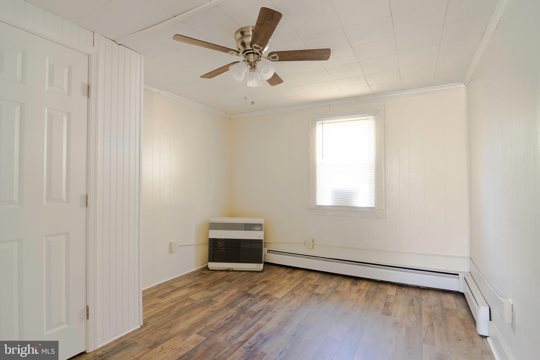 809 Truman Street Cambridge, MD 21613 - Photo 25 of 25 an empty room with wooden floor and ceiling fan