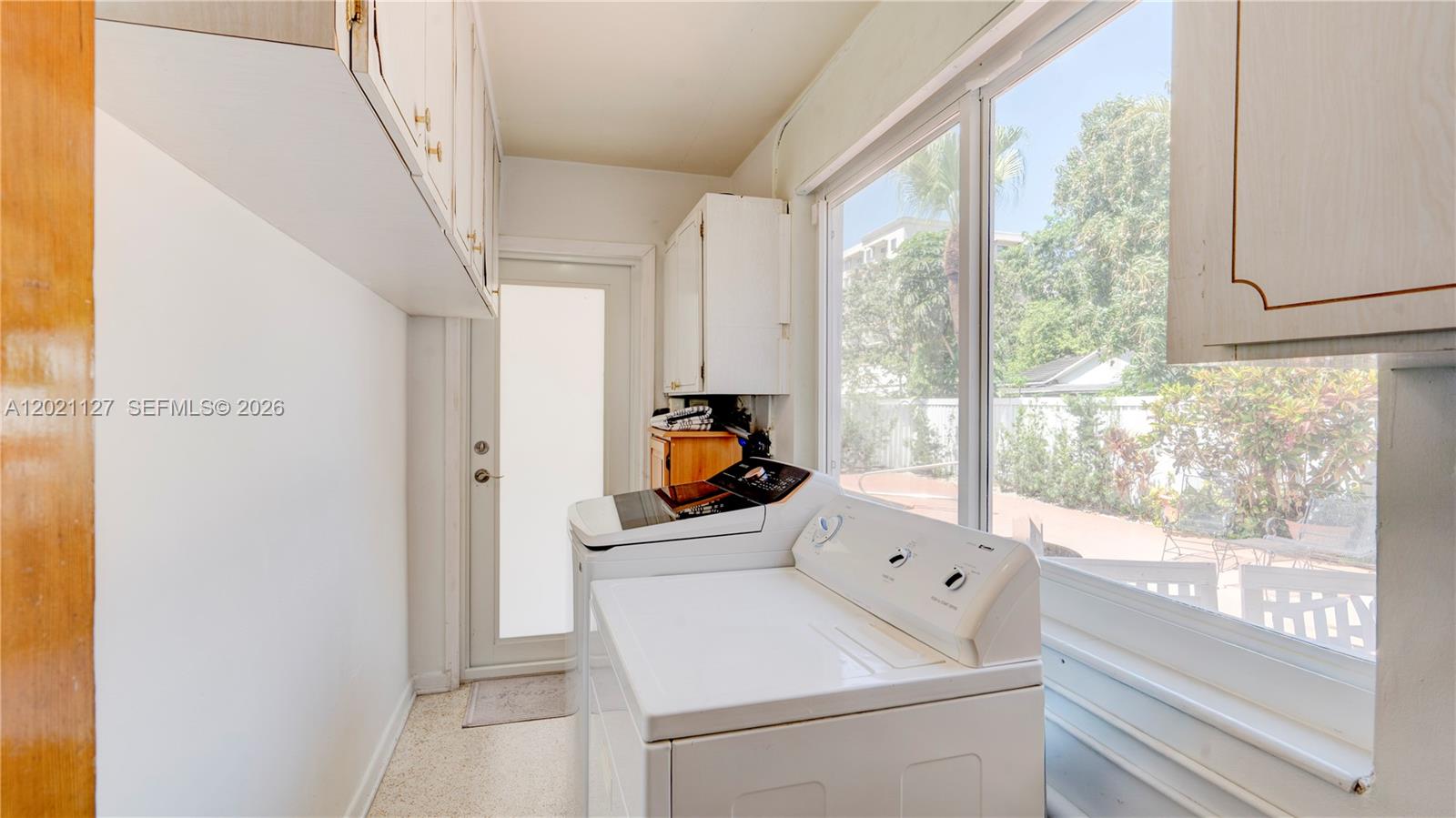 3611 Southwest 23rd Street Miami, FL 33145 - Photo 16 of 56 3613 - laundry with access to terrace and back yard with pool