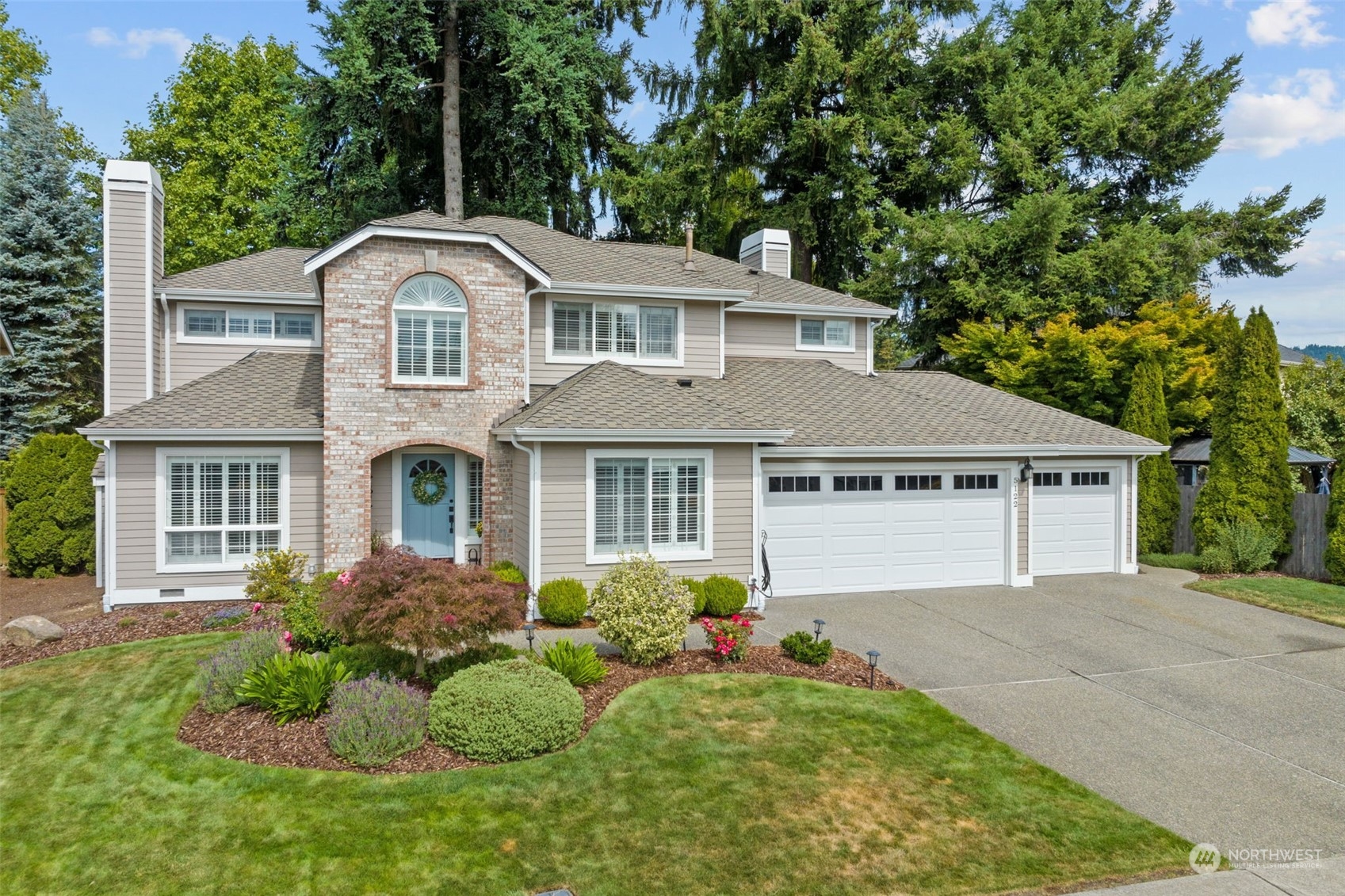 5122 Northeast 17th Street Renton, WA 98059 - Photo 1 of 35 a front view of a house with a garden